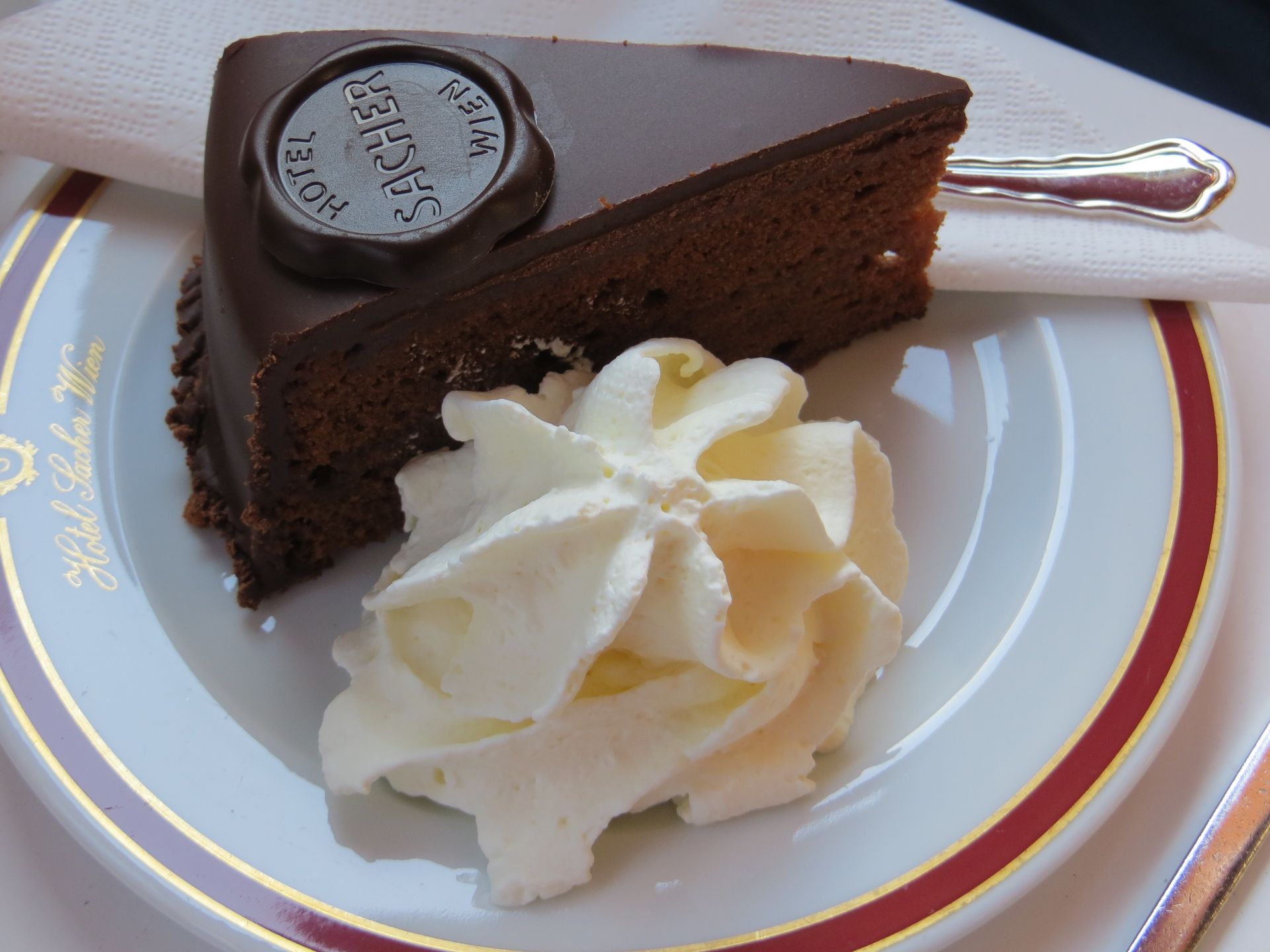 no visit to vienna would be complete without a stop in a historic coffee house eating a slice of sacher torte with whipped cream